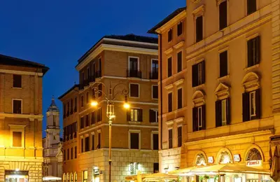 a group of buildings with a clock tower in the distance at Suite Art Navona in Rome