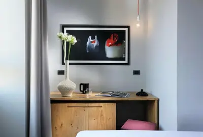 a room with a table with a vase of flowers at Suite Art Navona in Rome