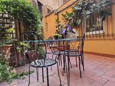 a table and chairs with plants on a patio at Pantheon, Campo de fiori mini garden in Rome