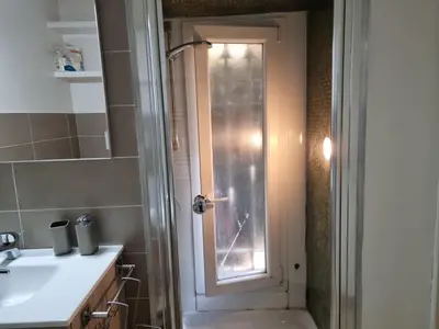 a bathroom with a sink and a door with a window at Pantheon, Campo de fiori mini garden in Rome