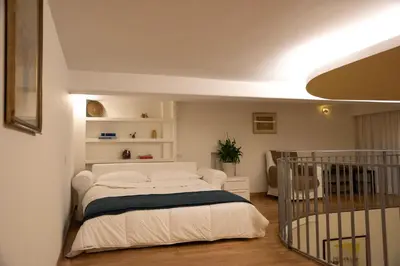 a bedroom with a white bed in a room at House Domusella in Rome