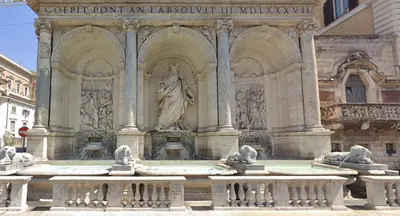 a statue of a woman in a fountain in a building at House Domusella in Rome