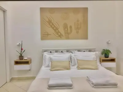 a bedroom with a large white bed with pillows at House Domusella in Rome