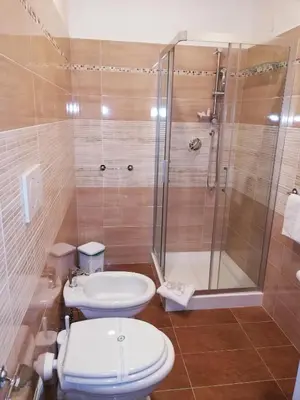 a bathroom with a shower and a toilet and a sink at Garden's Elide in Rome