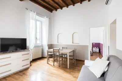 a living room with a couch and a table at A World Aparts - 105 Pellegrino in Rome