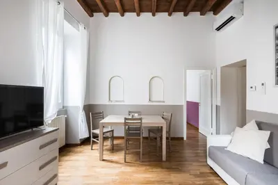 a living room with a table and a couch at A World Aparts - 105 Pellegrino in Rome