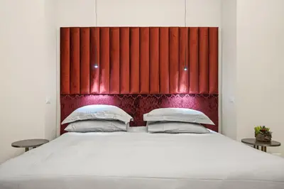 a bedroom with a large bed with a red headboard at Gh Trevi Fountain in Rome