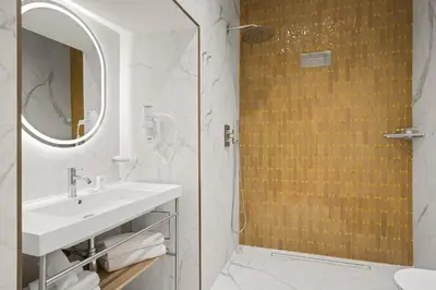 a bathroom with a sink and a shower with a mirror at Gh Trevi Fountain in Rome