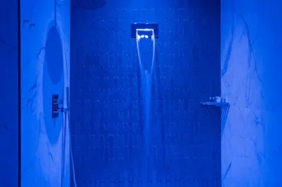 a shower with blue lighting in a bathroom at Gh Trevi Fountain in Rome