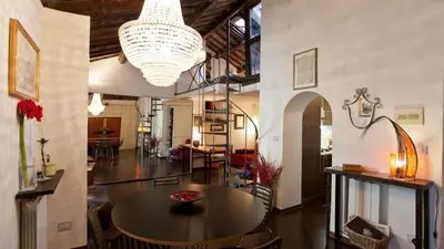 a large room with a table and a chandelier at Rental in Rome Loft Cappellari in Rome