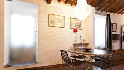 a dining room with a table and chairs at Rental in Rome Loft Cappellari in Rome
