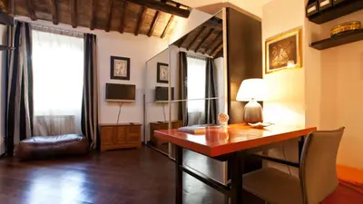 a living room with a desk and a television at Rental in Rome Loft Cappellari in Rome