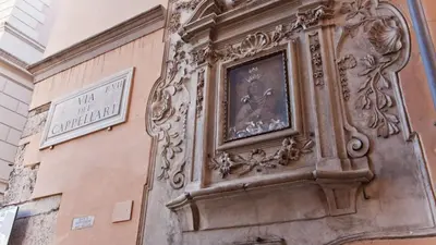 a clock on the side of a building at Rental in Rome Loft Cappellari in Rome