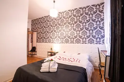 a bedroom with a bed with two towels on it at Ostiense Suites in Rome
