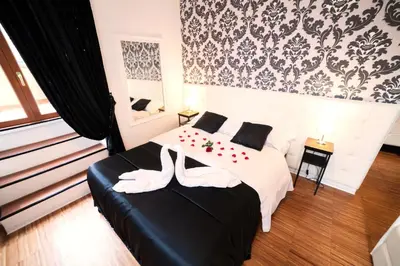 a bedroom with a bed with two shoes on it at Ostiense Suites in Rome