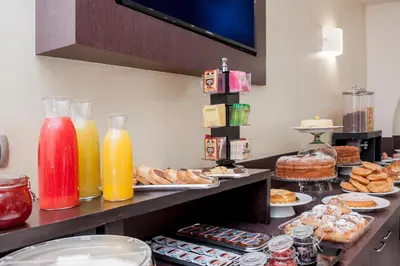 a buffet line with different types of pastries and drinks at Demetra Hotel in Rome