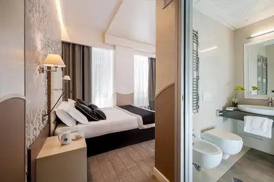 a hotel room with a bed and a bathroom at Demetra Hotel in Rome