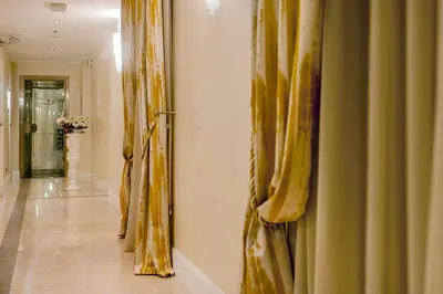 a hallway with curtains on the walls and a hallwayngth at Demetra Hotel in Rome