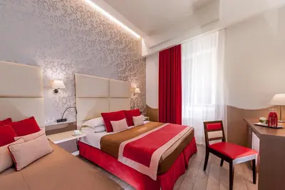 a hotel room with a bed and a chair at Demetra Hotel in Rome