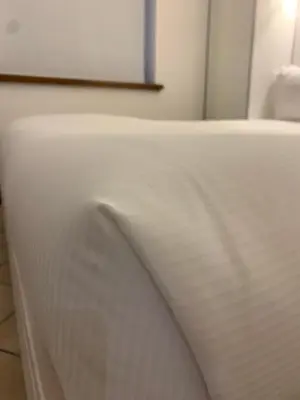 a close up of a white bedsheet on a bed at Albergo Delle Regioni, Barberini - Fontana di Trevi in Rome