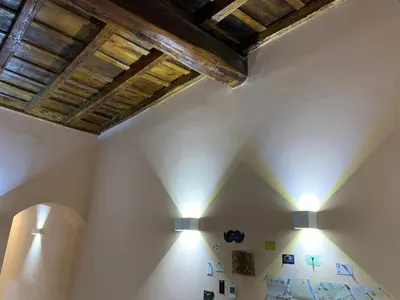 a room with two lights on the wall at Albergo Delle Regioni, Barberini - Fontana di Trevi in Rome