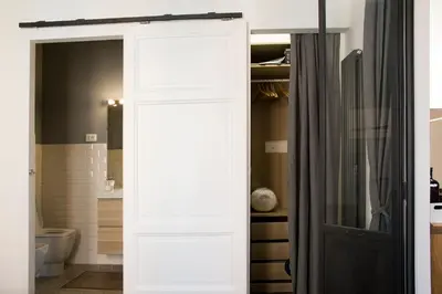a white door in a bathroom with a toilet at Appart in Rome