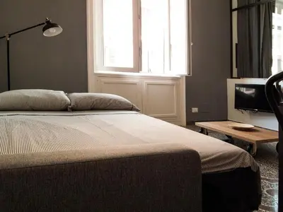 a bedroom with a bed and a television and a window at Appart in Rome