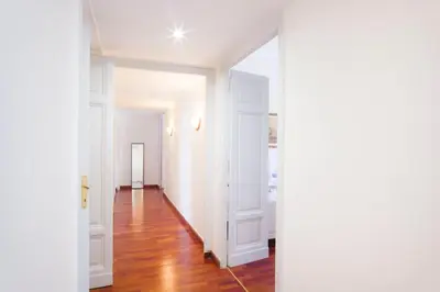 an empty hallway with white walls and wood floors at Leonardo Suite Navona in Rome