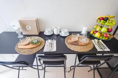 a black table with two chairs and a bowl of fruit at Leonardo Suite Navona in Rome