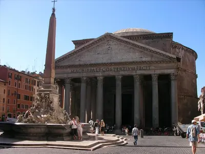 a large building with a fountain in front of it at Leonardo Suite Navona in Rome