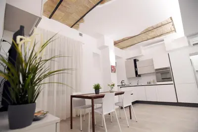 a kitchen and dining room with a table and chairs at LATERANO 250 - COLOSSEO in Rome