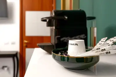 a bowl on a counter with a cup and a coffee mug at Colosseo Relais in Rome
