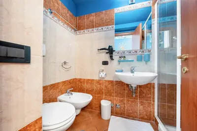 a bathroom with a toilet and a sink at Colosseo Relais in Rome