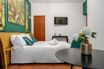 a hotel room with a bed and a table at Colosseo Relais in Rome