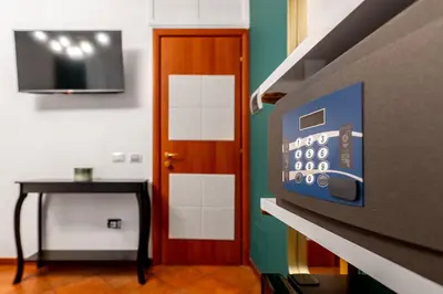 a room with a tv and a table and a door at Colosseo Relais in Rome