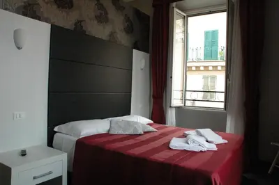 a hotel room with a bed with towels on it at Morfeo Suite in Rome