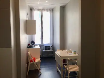 a small room with a table and a microwave at Morfeo Suite in Rome