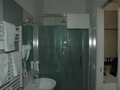 a bathroom with a shower and a sink and a shower at Morfeo Suite in Rome