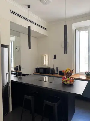 a kitchen with a bowl of fruit on a counter at STAY FINE Holiday’s House in Rome