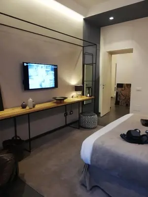 a hotel room with a television on a wall at STAY FINE Holiday’s House in Rome
