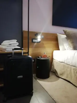 a bedroom with a black suitcase next to a bed at STAY FINE Holiday’s House in Rome