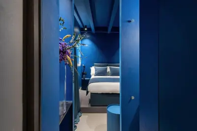 a bedroom with blue walls and a bed in a room at Elysium Suites collection in Rome