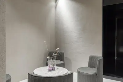 two chairs and a table with a vase of flowers at Elysium Suites collection in Rome