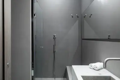 a bathroom with a shower with a sink and a shower at Elysium Suites collection in Rome