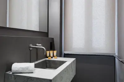 a bathroom with a sink with a towel at Elysium Suites collection in Rome