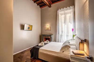 a bedroom with a large bed and a window at The Spanish steps apartment 67 in Rome