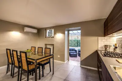 a kitchen and dining room with a table and chairs at The Spanish steps apartment 67 in Rome