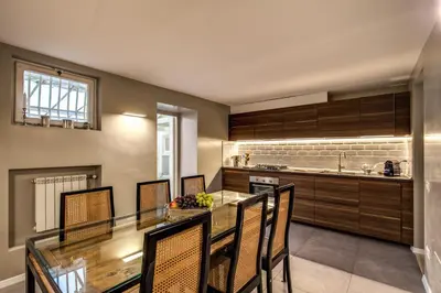 a kitchen with a long dining table and chairs at The Spanish steps apartment 67 in Rome