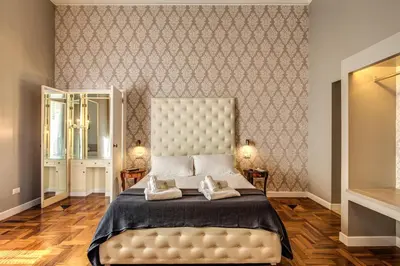 a bedroom with a large bed with two towels on it at The Spanish steps apartment 67 in Rome
