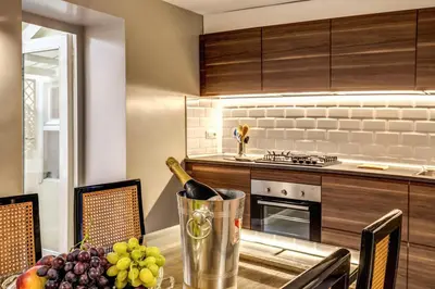a kitchen with a table with a bottle of wine at The Spanish steps apartment 67 in Rome